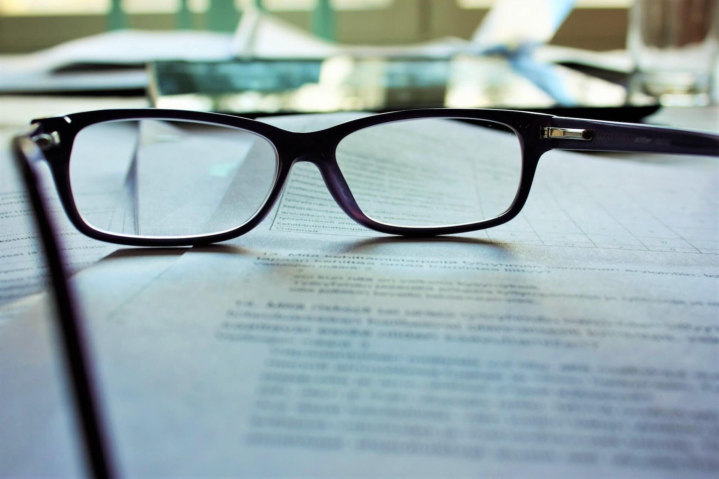 Pair of glasses resting on a contract Pair of glasses resting on a contract