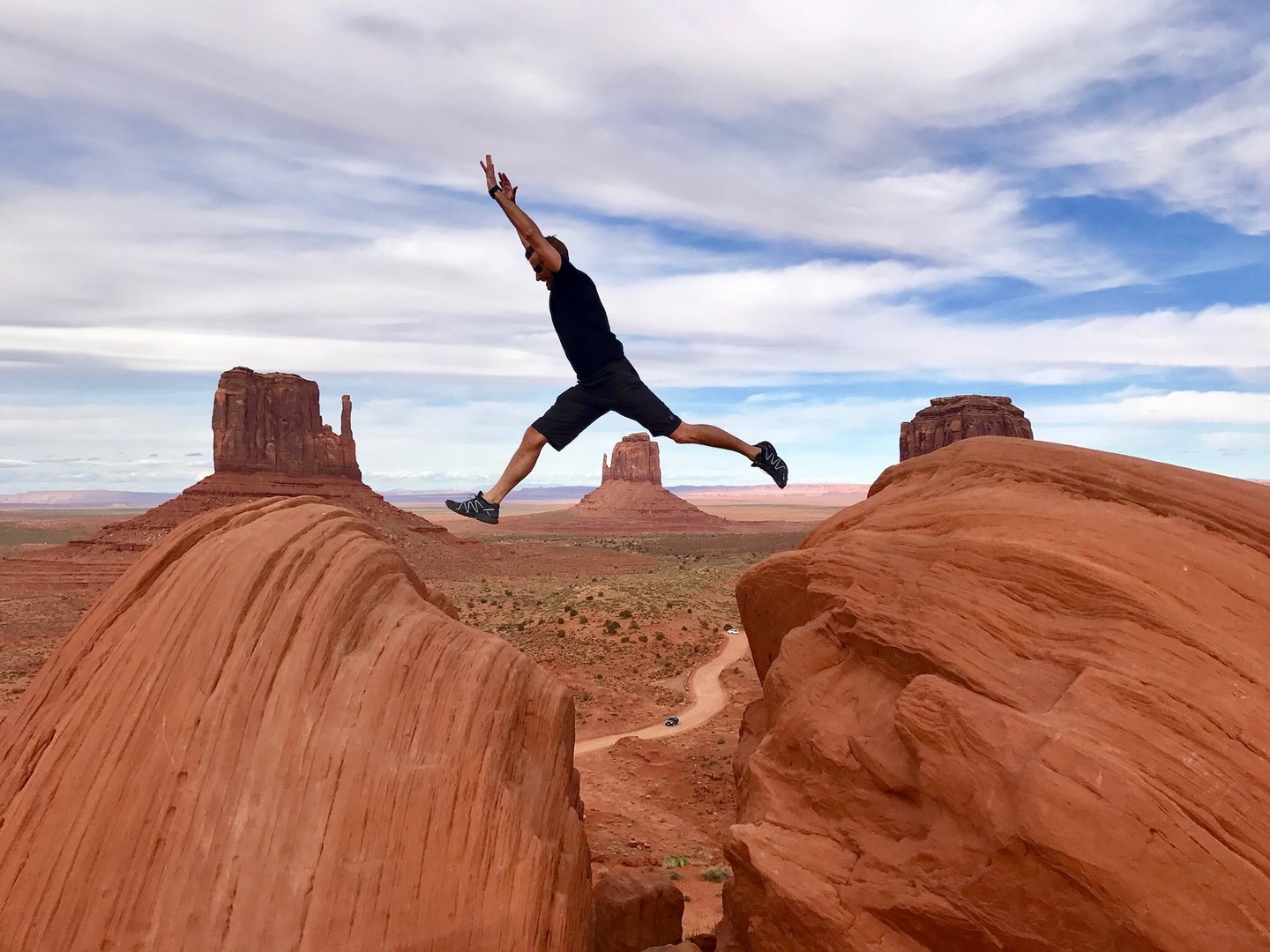 Man jumping over a ravine Man jumping over a ravine