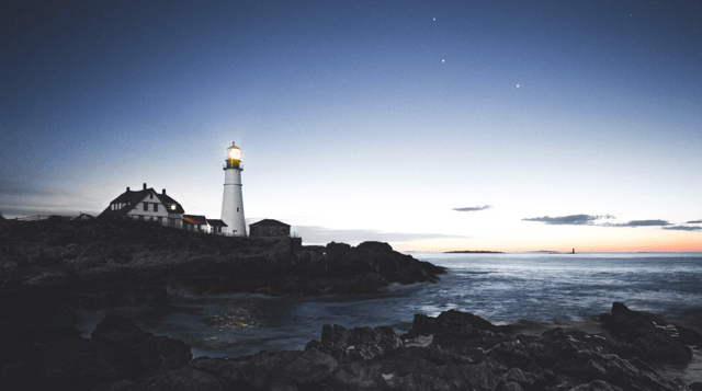 Lighthouse surrounded by sea and rocks Lighthouse surrounded by sea and rocks